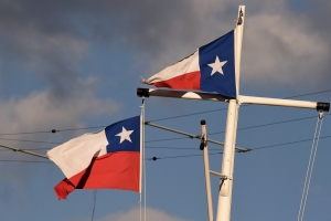Texas flags flying in the sky